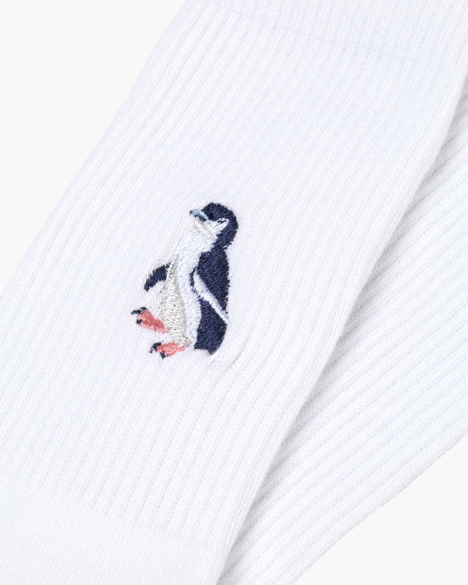 white sports sock with a penguin design