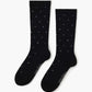 black crew sock with a pattern of small multicolored polka dots