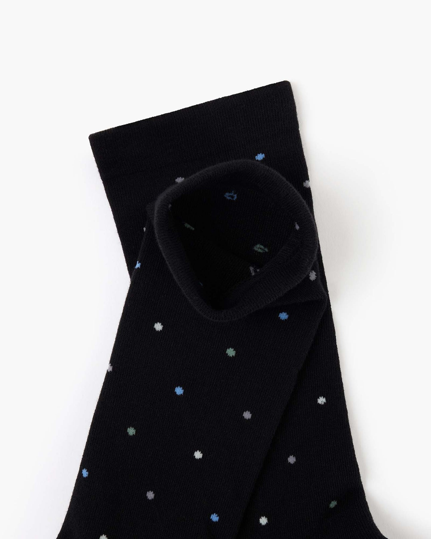 black crew sock with a pattern of small multicolored polka dots