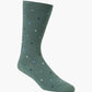 green crew sock with a scattered pattern of small polka dots in white, light blue, and black