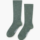 green crew sock with a scattered pattern of small polka dots in white, light blue, and black