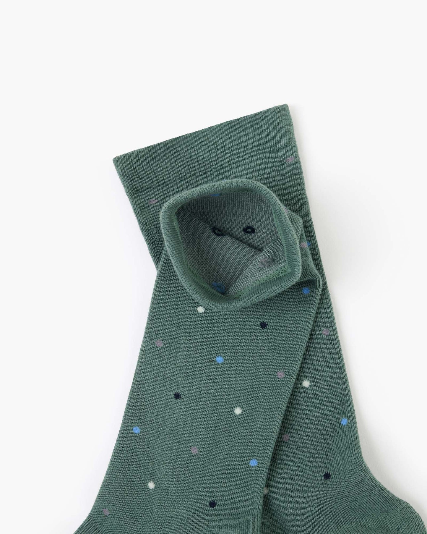 green crew sock with a scattered pattern of small polka dots in white, light blue, and black