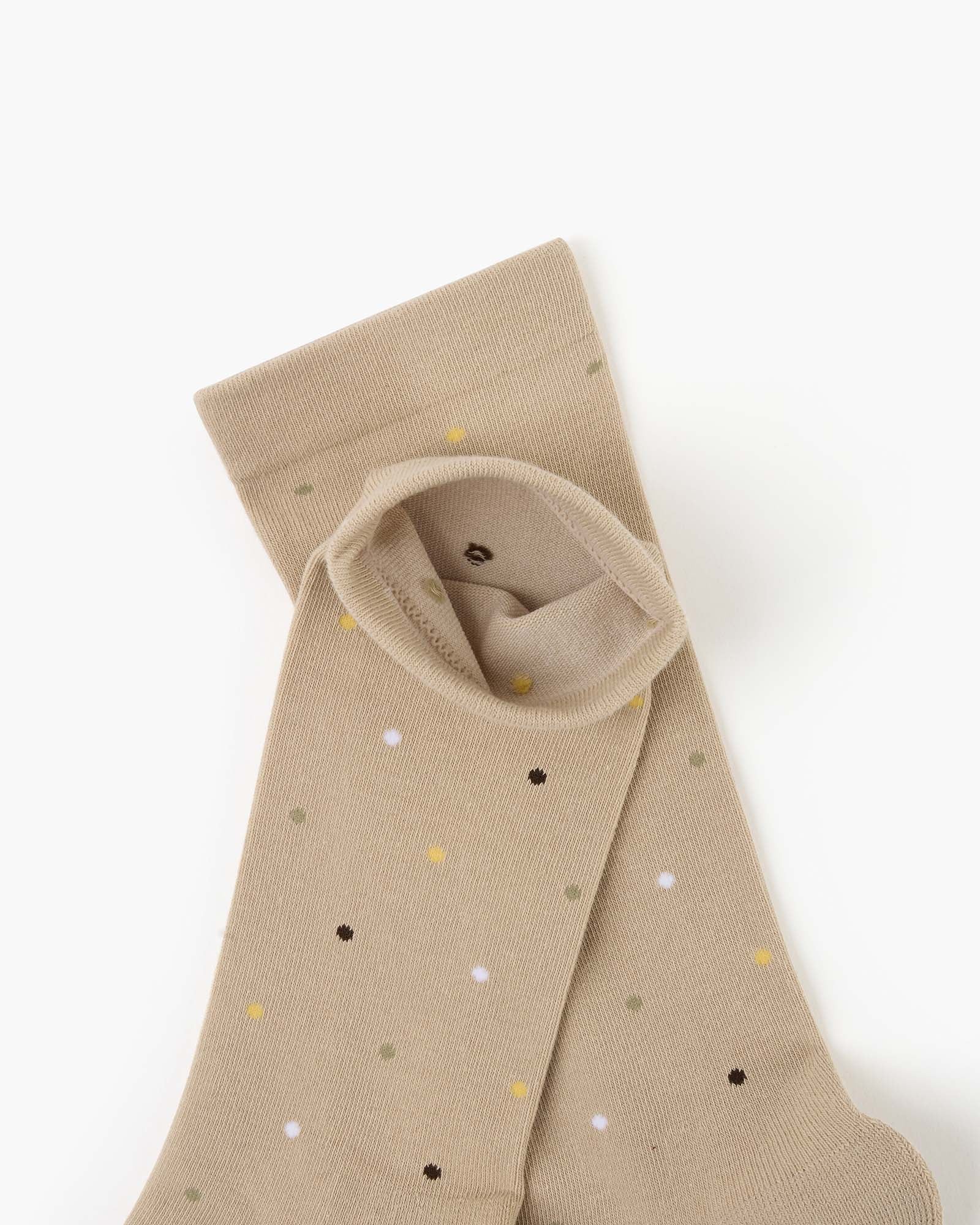 beige crew socks with a pattern of small multicolored polka dots