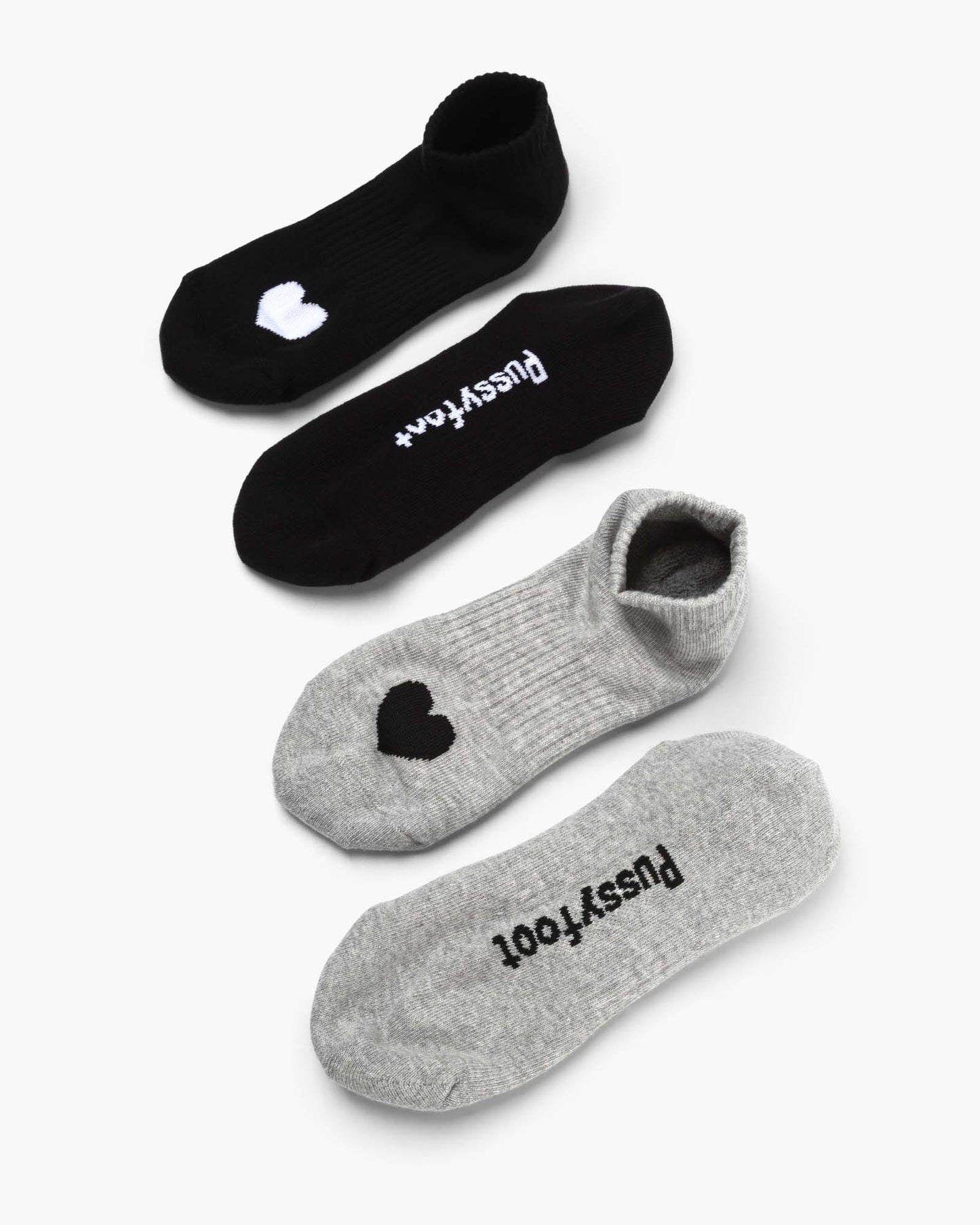 Two pairs of ankle socks, one black and one grey, with love heart print design 